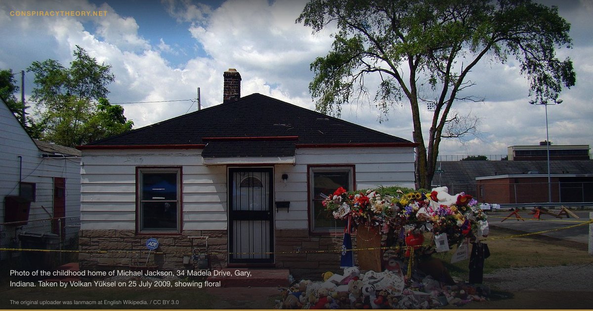 Michael Jackson Faked His Death (2009-06-25) — Photo of the childhood home of Michael Jackson, 34 Madela Drive, Gary, Indiana. Taken by Volkan Yüksel on 25 July 2009, showing floral tributes after Jackson's death. Copyright released at en:Talk:Michael_Jackson#MJ_Birth_Place_and_location_on_Panoramio. The Original Panoramio Page where this photo was made accessible to public for view the first time. It also has map indicating exact location of the place where this photo was taken. The Panoramio Page for the new photo taken by Volkan Yuksel on 17 October 2010 showing the erected monument and renovation of the house. It also has map indicating exact location of the place where the photo was taken.